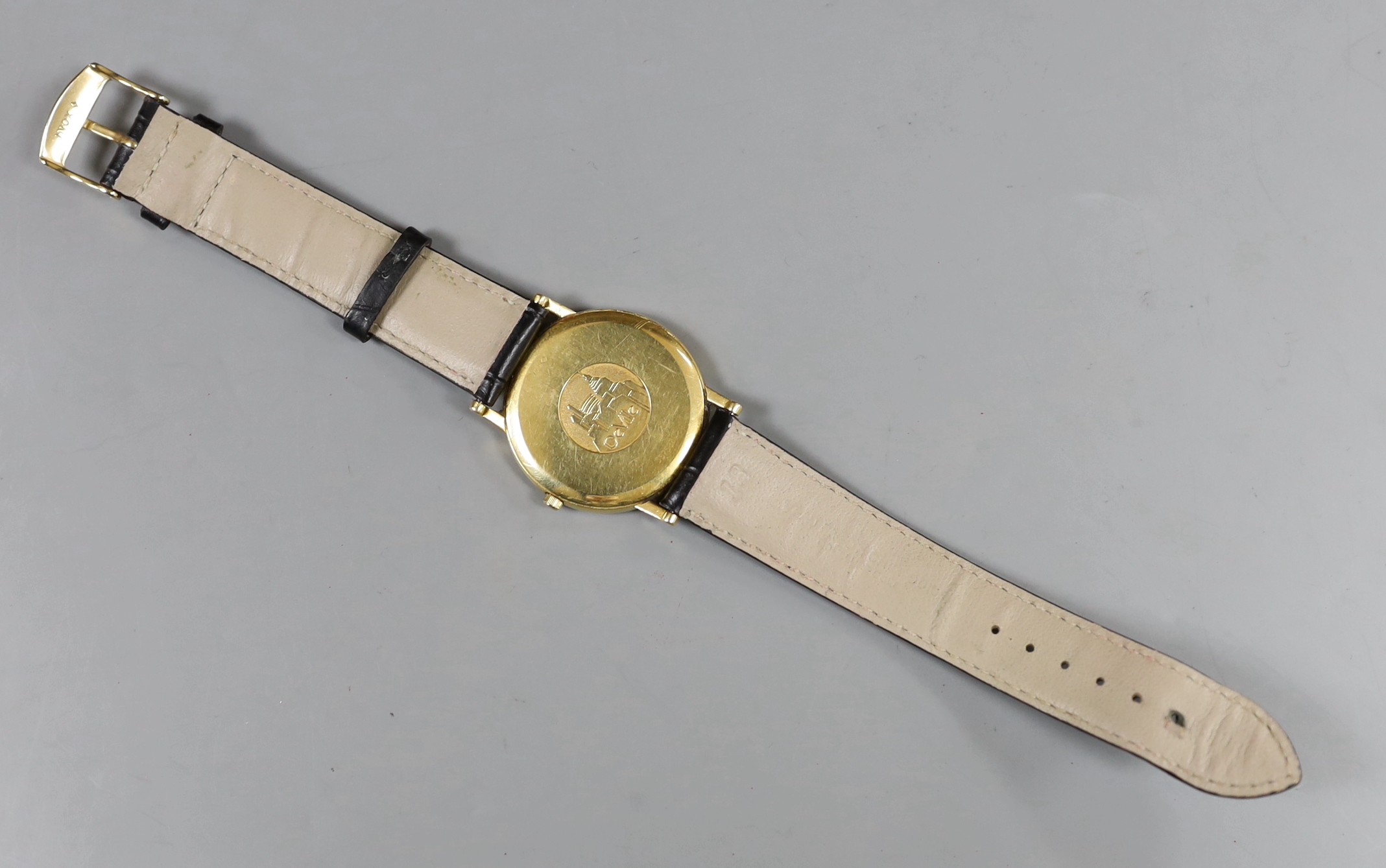 A gentleman's 18ct gold Omega De Ville quartz wrist watch, on associated leather strap, with Omega box.